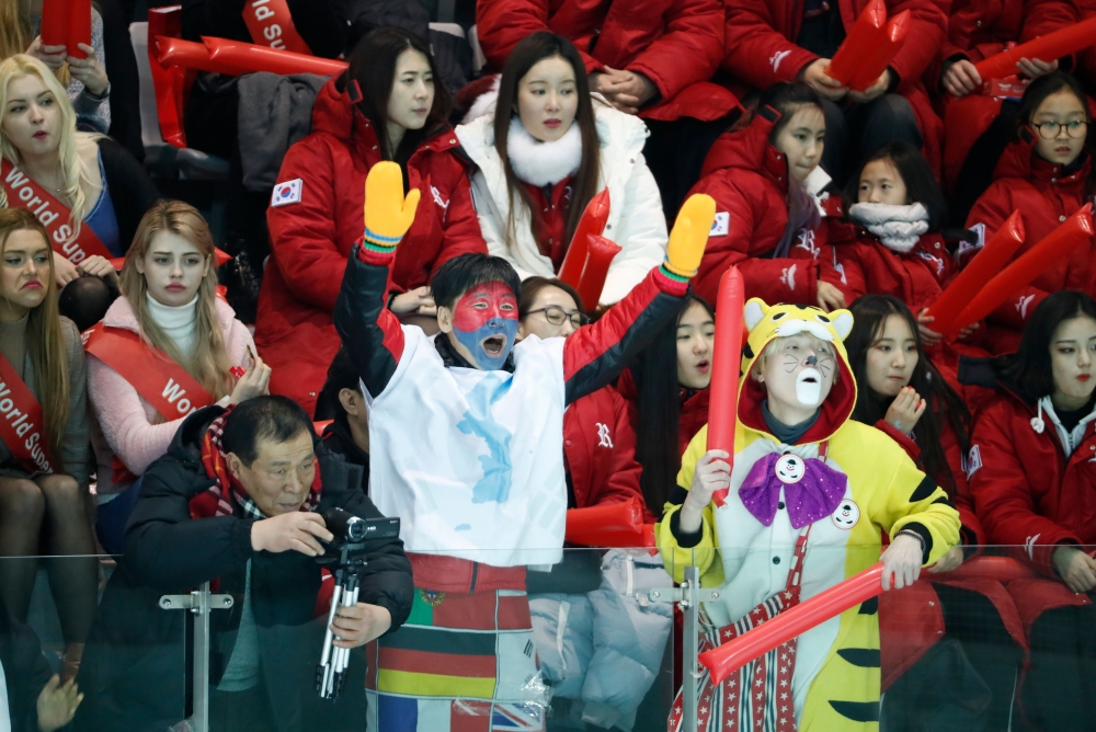 Supporters cheer during a women's ice hockey practice match between Sweden and a Unified Korean team in Incheon on February 4, 2018 ahead of the Pyeongchang 2018 Winter Olympic Games.  AFP / POOL / KIM HONG-JI