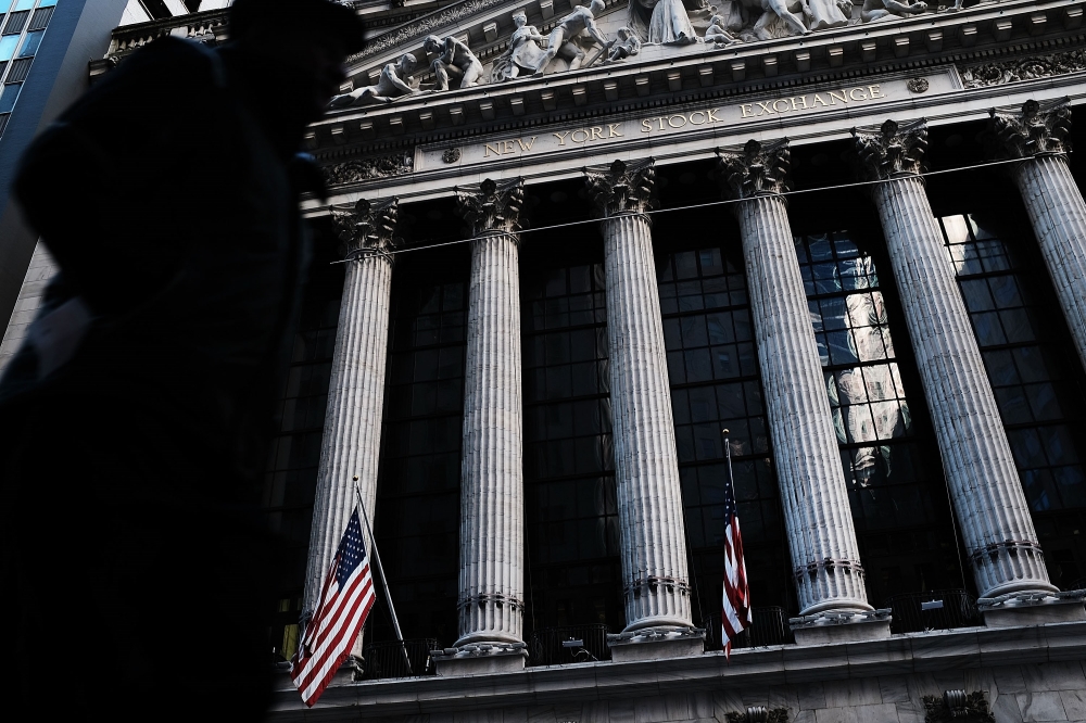 People walk by the New York Stock Exchange (NYSE) on February 5, 2018 in New York City. Spencer Platt/Getty Images/AFP