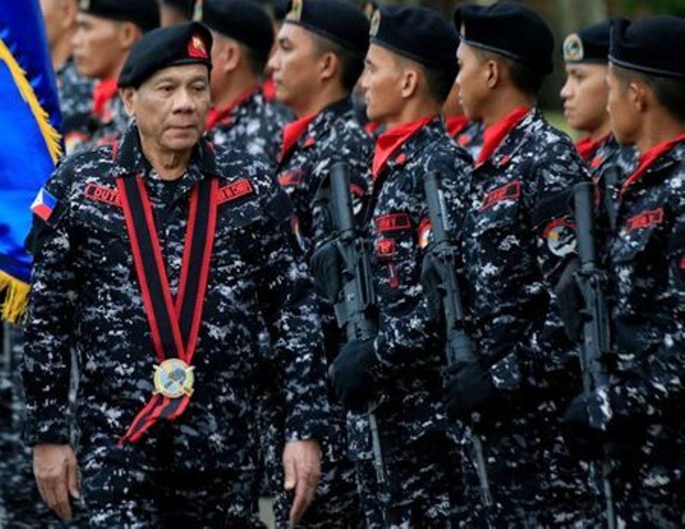 File photo of Philippine President Rodrigo Duterte, wearing a military uniform, reviews scout ranger troops upon his arrival during the 67th founding anniversary of the First Scout Ranger regiment in San Miguel town, Bulacan province, north of Manila, Phi