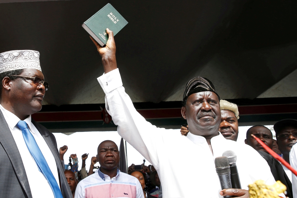 Kenyan opposition leader Raila Odinga of the National Super Alliance (NASA) holds a bible as he takes a symbolic presidential oath of office in Nairobi, Kenya January 30, 2018. Reuters/Baz Ratne