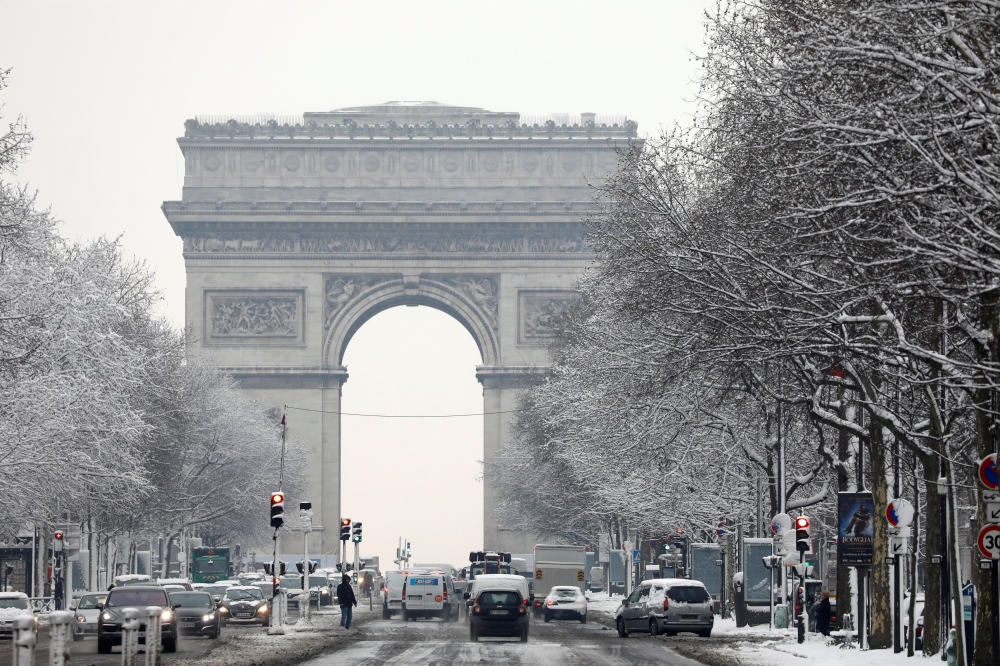  A view shows the traffic on the snow-covered Champs-Elysees avenue below the Arc de Triomphe in Paris, as winter weather with snow and freezing temperatures arrive in France, February 7, 2018. Reuters/Charles Platiau