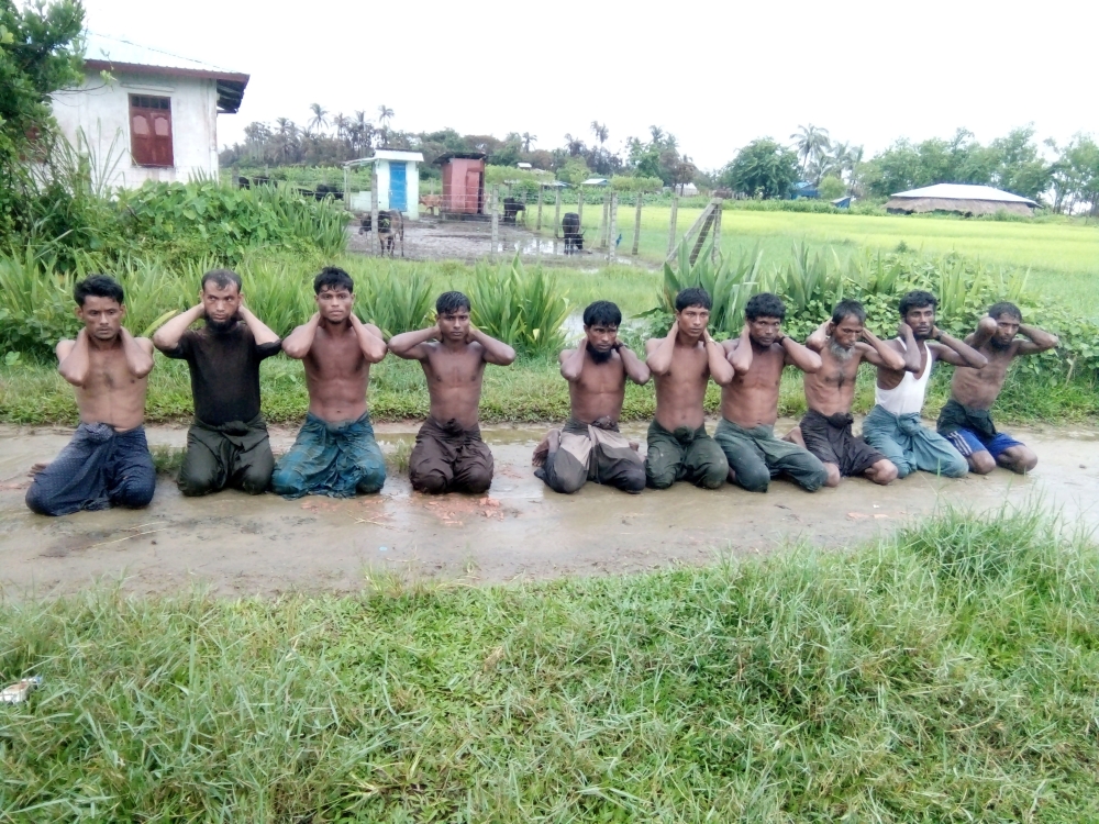 Ten Rohingya Muslim men with their hands bound kneel in Inn Din village September 1, 2017. Handout via Reuters