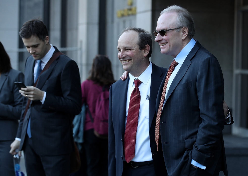 Uber attorney Bill Carmody (R) and Waymo attorney Charles Verhoeven (L) pose for a photo outside of the Phillip Burton Federal Building after the Waymo-Uber technology theft trial was dismissed on February 9, 2018 in San Francisco, California.  Justin Sul