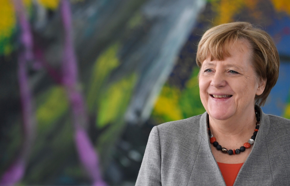 German Chancellor Angela Merkel walks out of her office to meet the President of the German Horticultural Association in the chancellery in Berlin, Germany, February 9, 2018. AFP / John MACDOUGALL
