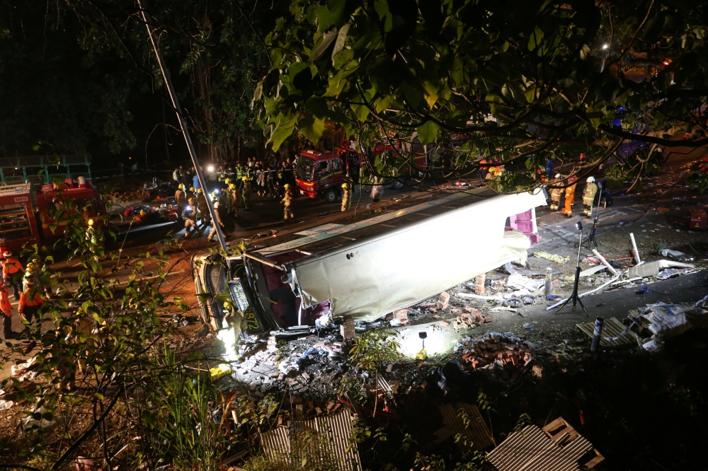 Rescuers work at the site of a crashed bus in Hong Kong, China February 10, 2018. China Daily via REUTERS 