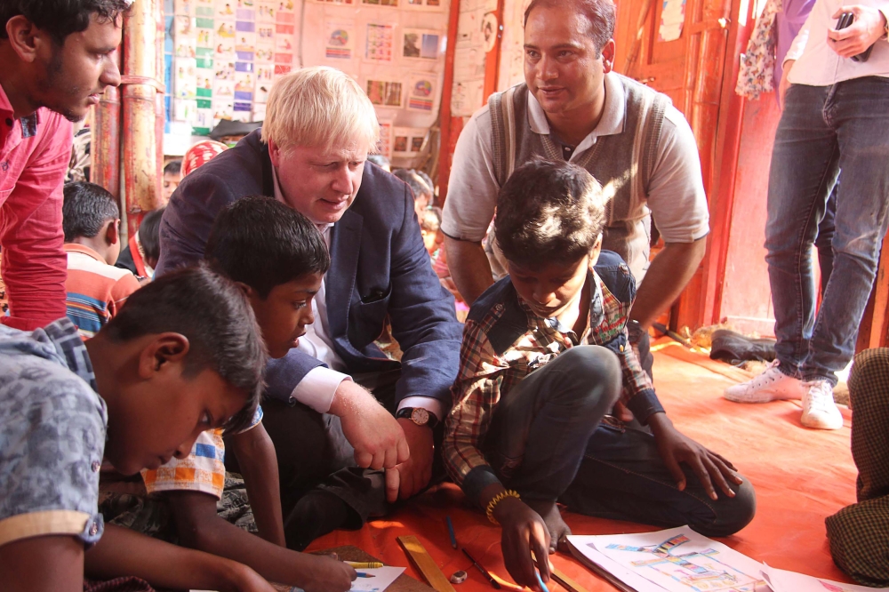 British Foreign Secretary Boris Johnson (C) meets with Rohingya refugees at a camp in Bangladesh's Cox's Bazar district on February 10, 2018. AFP 