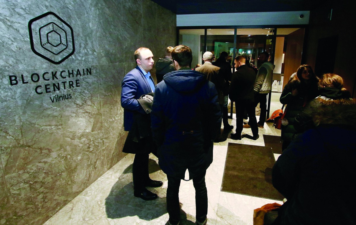 People arrive for a presentation at the blockchain centre, which aims at boosting start-ups, on February 7, 2018 in Lithuania's capital Vilnius.  AFP / Petras Malukas
