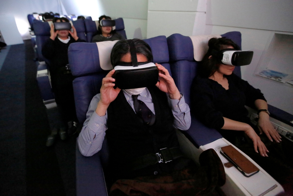 Guests wearing virtual reality (VR) goggles are seen at the 