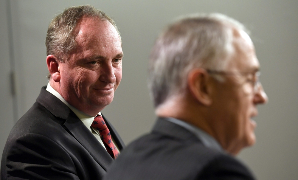 (FILES) This file photo taken on July Australia's Deputy Prime Minister Barnaby Joyce (L) looking at Prime Minister Malcolm Turnbull (R) during a press conference in Sydney. AFP / William West 