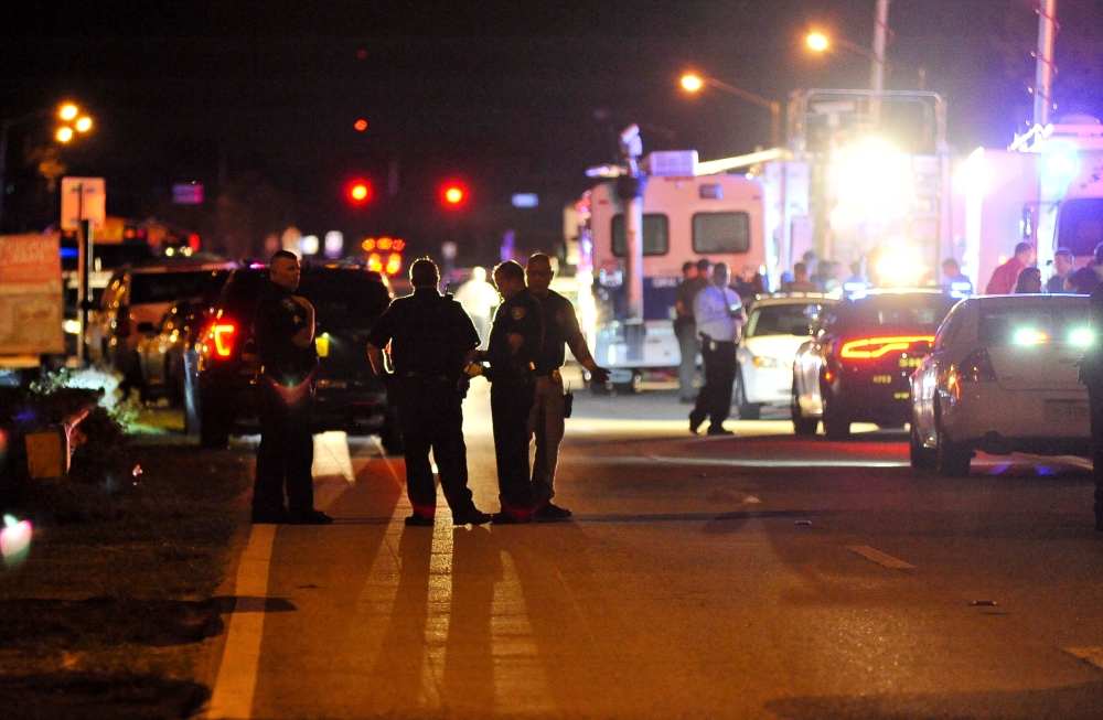Police vehicles block the road to Marjory Stoneman Douglas High School in Parkland, Florida, following a shooting that killed 17 people on February 14, 2018 in Parkland, Florida. AFP / Gaston De Cardenas