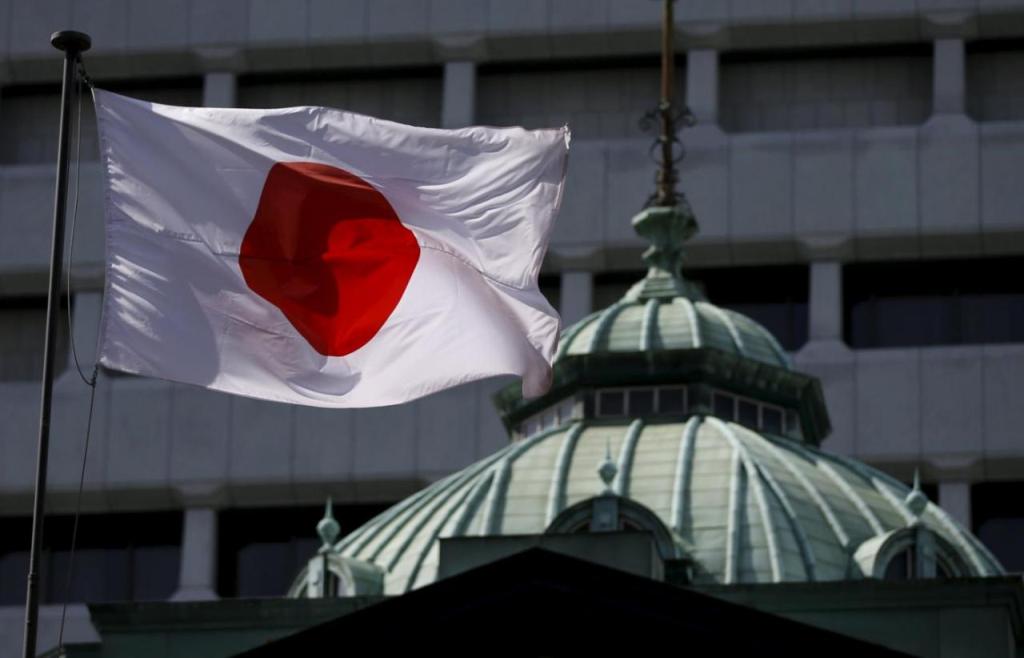 File photo of a Japanese flag fluttering atop the Bank of Japan building in Tokyo May 22, 2015. REUTERS/Toru Hanai