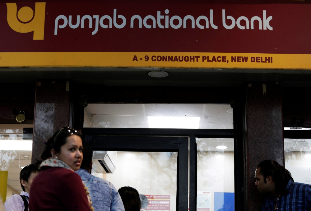People wait in a queue outside a Punjab National Bank ATM in New Delhi, India, February 16, 2018. REUTERS/Saumya Khandelwal	

