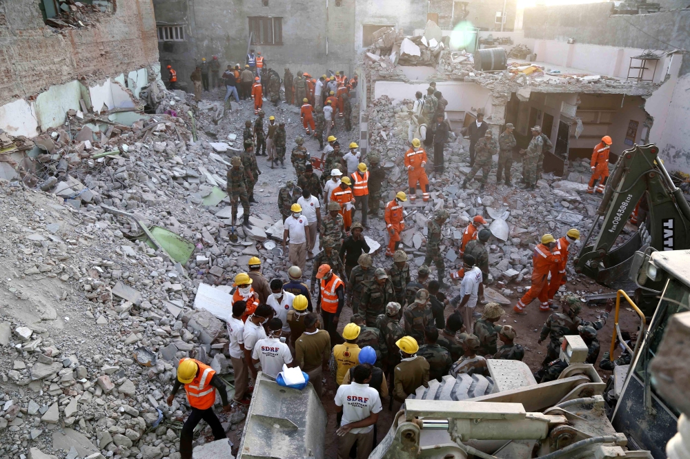 Indian Army, NDRF and SDRF personnel carry out rescue work after a building collapsed due to a gas cylinder blast during wedding party in Beawar, in the Indian state of Rajasthan on February 18, 2018. AFP 