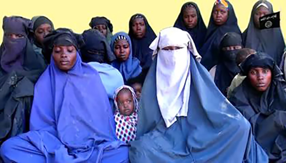 (FILES) This file handout video grab released by Islamist militants group Boko Haram on January 15, 2018 shows at least 14 of the schoolgirls abducted from the northeast Nigerian town of Chibok in April 2014.  AFP PHOTO 