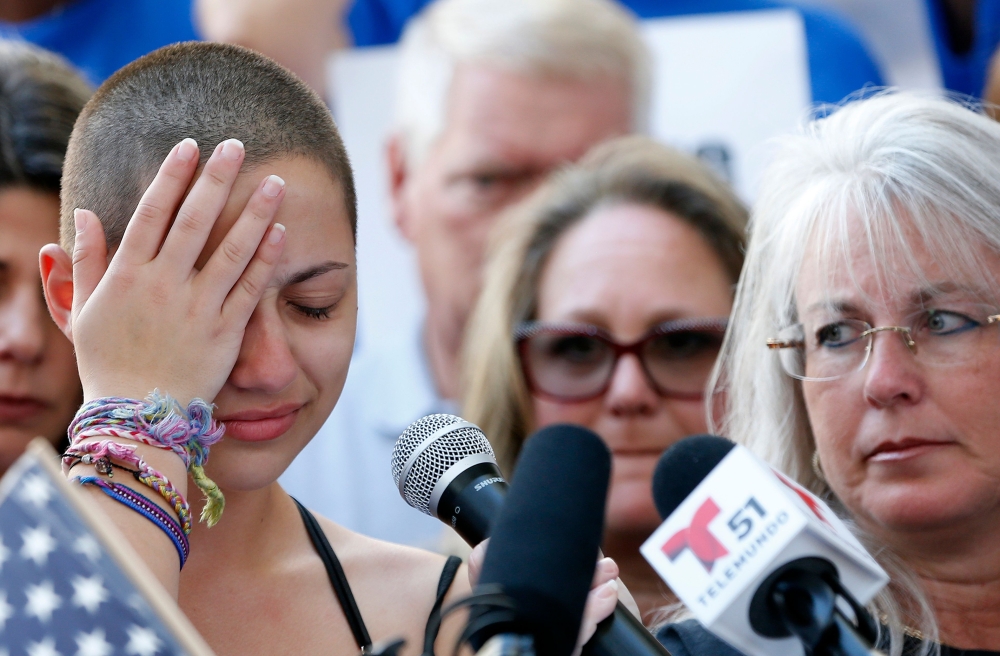 :(FILES) In this file photo taken on February 17, 2018 Marjory Stoneman Douglas High School student Emma Gonzalez reacts during her speech at a rally for gun control at the Broward County Federal Courthouse in Fort Lauderdale, Florida on February 17, 2018
