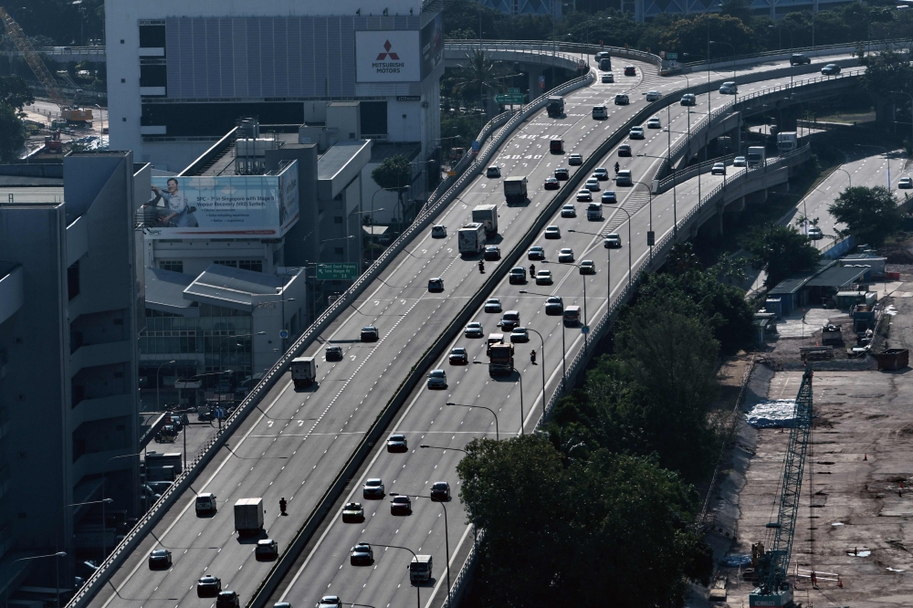 Motorists drive on an elevated highway in Singapore on February 19, 2018. Singapore will impose a carbon tax from next year to cut greenhouse gas emissions and make companies competitive as global agreements on climate change take effect, the government s