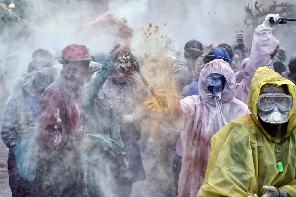 Revellers participate in a 'flour war' during 'Ash Monday' celebrations, a traditional festivity marking the end of the carnival season and the start of the 40-day Lent period until the Orthodox Easter, in the port town of Galaxidi, Greece, on February 19