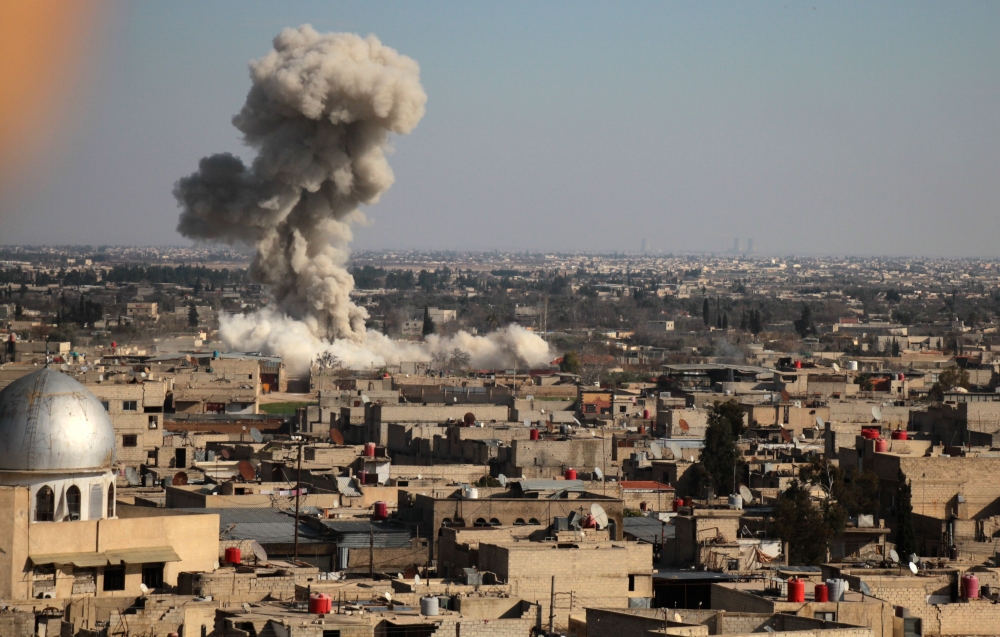 Smoke rises from buildings following bombardment on the village of Mesraba in the rebel-held besieged Eastern Ghouta region on the outskirts of the capital Damascus, on February 19, 2018. AFP / Hamza Al-Ajweh
