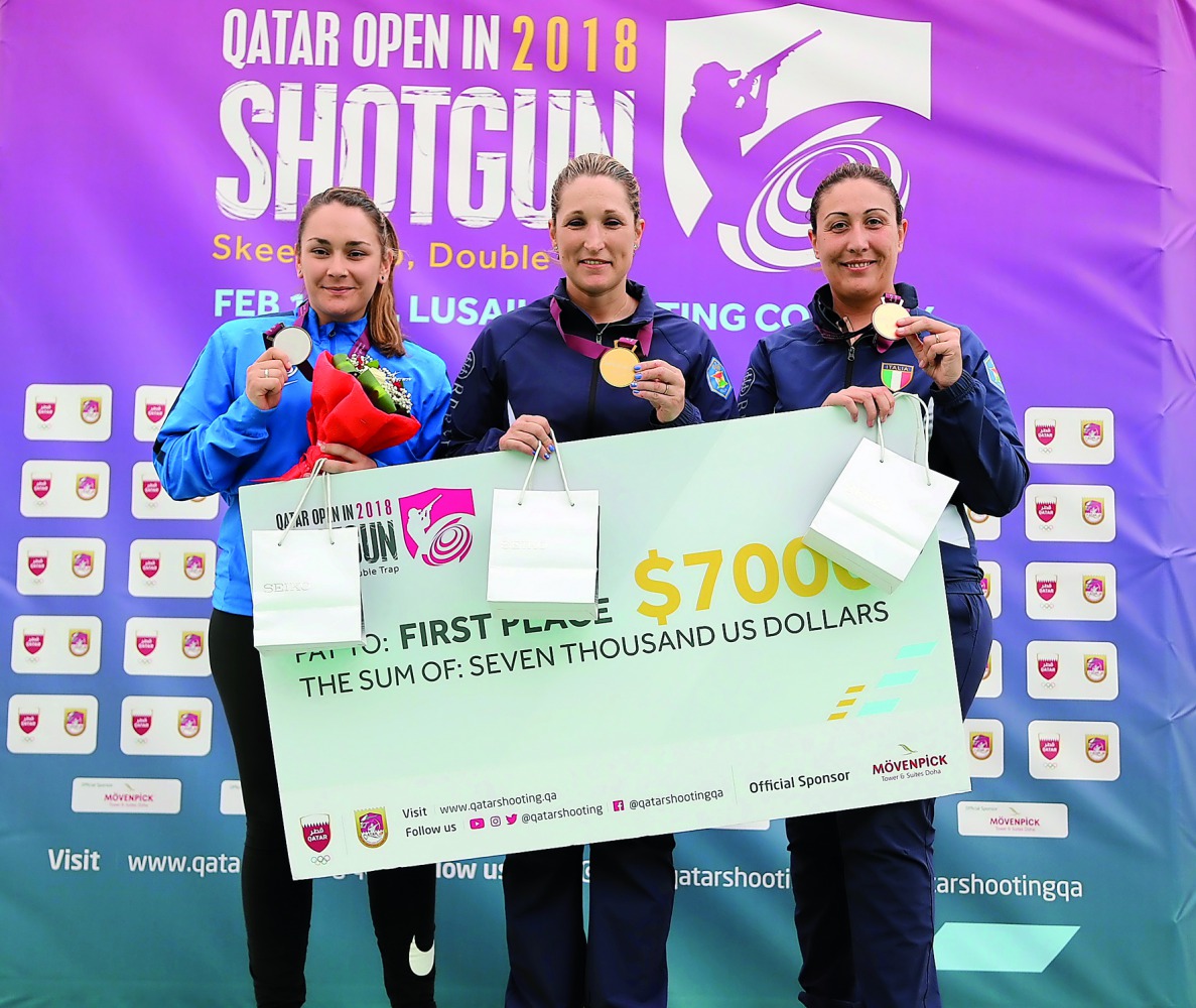 Italian Olympic champions Chiara Cainero (centre) and Diana Bacosi (right) are seen along with France’s Lucie Anastassiou during the victory ceremony at the Losail Shooting Range during the Qatar Open Shotgun Championship.