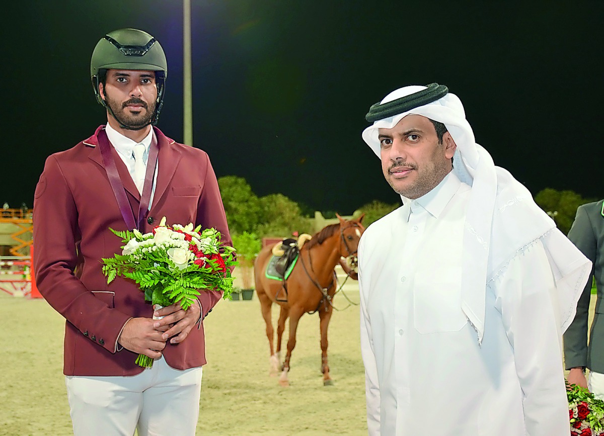 Qatari rider Mubarak Yousuf Al Rumaihi poses for a photograph with Qatar Equestrian Federation (QEF) President Hamad bin Abdulrahman Al Attiyah during the presentation ceremony. 