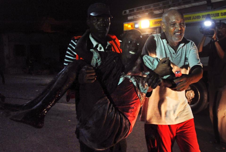 FILE PHOTO: Residents help a man wounded during an attack in the center of Mogadishu on February 26, 2016. (AFP / Mohamed Abdiwahab) 