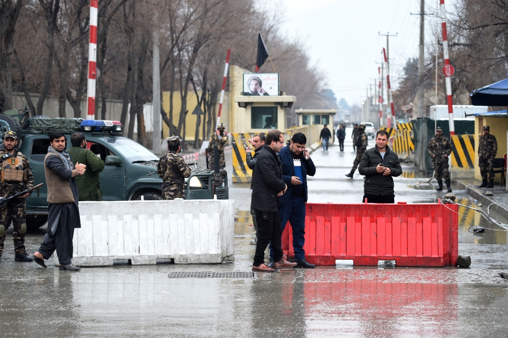 Afghan security personnel stand guard near the site of a suicide bombing at Shash Darak in kabul on February 24, 2018. AFP / WAKIL KOHSAR
