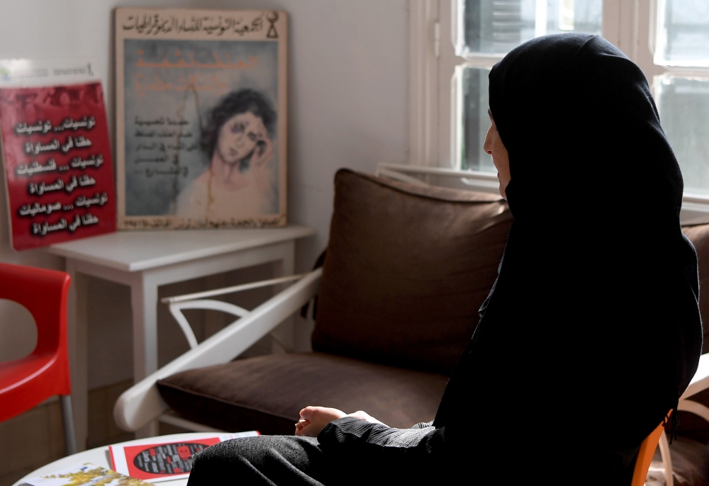 Sameh, a mother of two who suffered psychological abuse at the hand of her husband, speaks to a reporter in Tunis on February 20, 2018.  / AFP / FETHI BELAID 