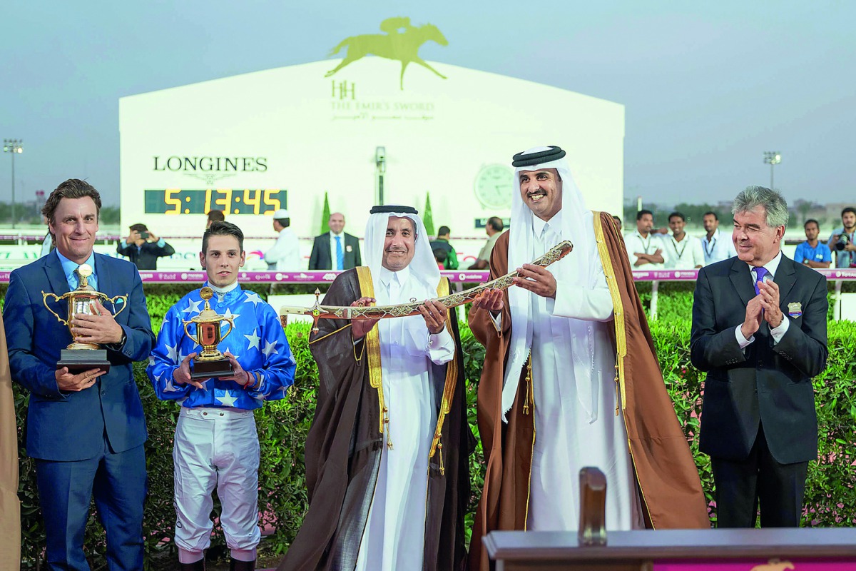 The Emir H H Sheikh Tamim bin Hamad Al Thani handing over the Emir’s Golden Sword to H E Sheikh Mohammed bin Khalifa Al Thani, the owner of winning horse Gazwan during the presentation ceremony held at the  Qatar Racing and Equestrian Club yesterday. Gazw