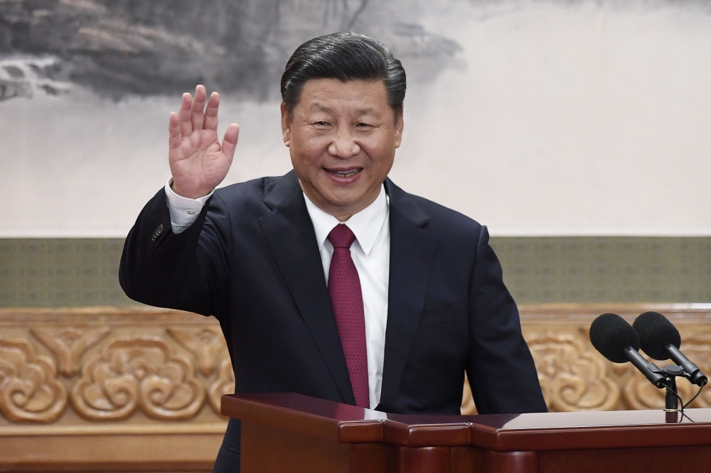 This file photo taken on October 25, 2017 shows Chinese President Xi Jinping waving at the Great Hall of the People in Beijing. AFP / WANG ZHAO