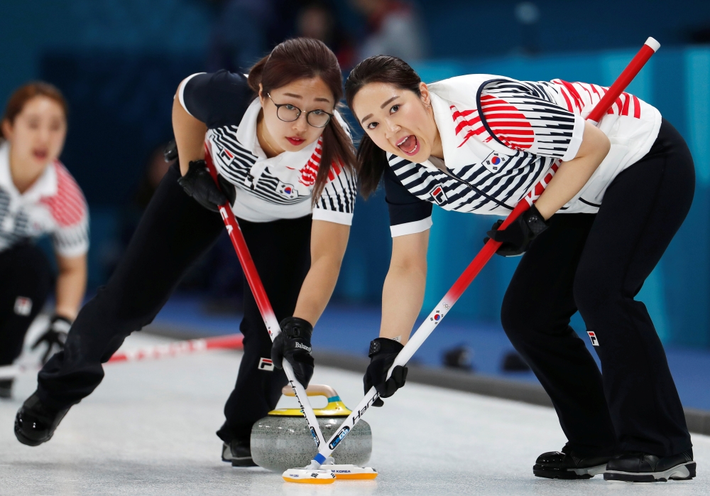 Kim Kyeong-ae and Kim Seo-yeong of South Korea sweep. REUTERS/Cathal McNaughton/File Photo