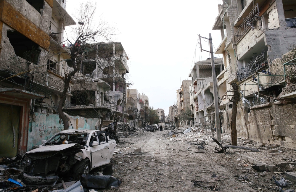 Damaged cars and buildings are seen in the besieged town of Douma, Eastern Ghouta, Damascus, Syria February 25, 2018. REUTERS/Bassam Khabieh
