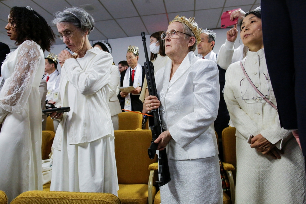 A woman holds her AR-15-style rifle as people attend a blessing ceremony with their AR-15-style rifles in their cases at the Sanctuary Church in Newfoundland, Pennsylvania, U.S., February 28, 2018. Reuters/Eduardo Munoz