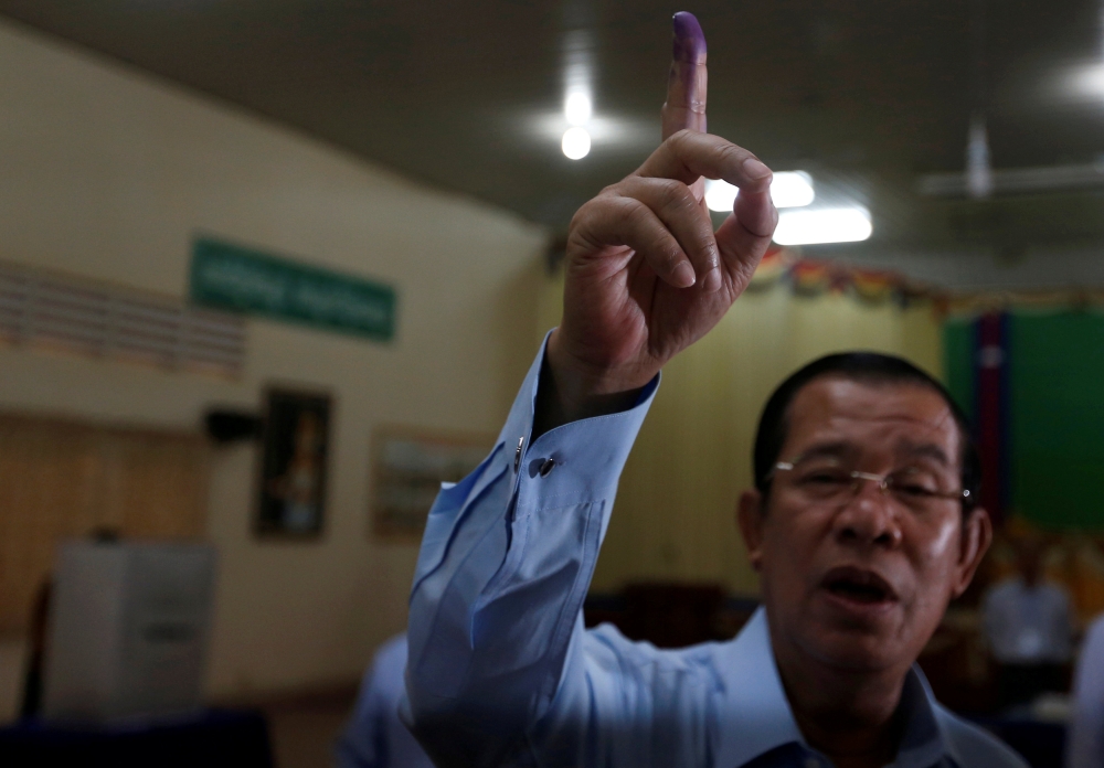 Cambodia's Prime Minister and President of the Cambodian People's Party (CPP), Hun Sen shows his ink-stained finger during a Senate election in Takhmao, Kandal province, Cambodia February 25, 2018. REUTERS/Samrang Pring	