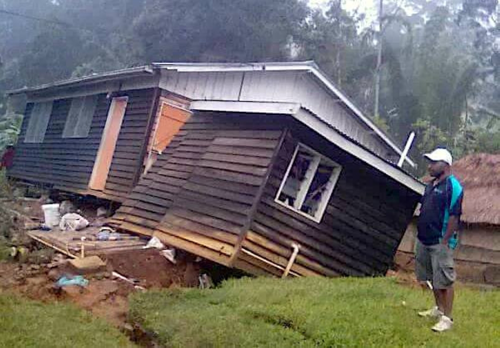 A local stands next to a damaged house near a landslide in the town of Tari after an earthquake struck Papua New Guinea's Southern Highlands in this image taken February 27, 2018 obtained from social media. Francis Ambrose/via REUTERS 