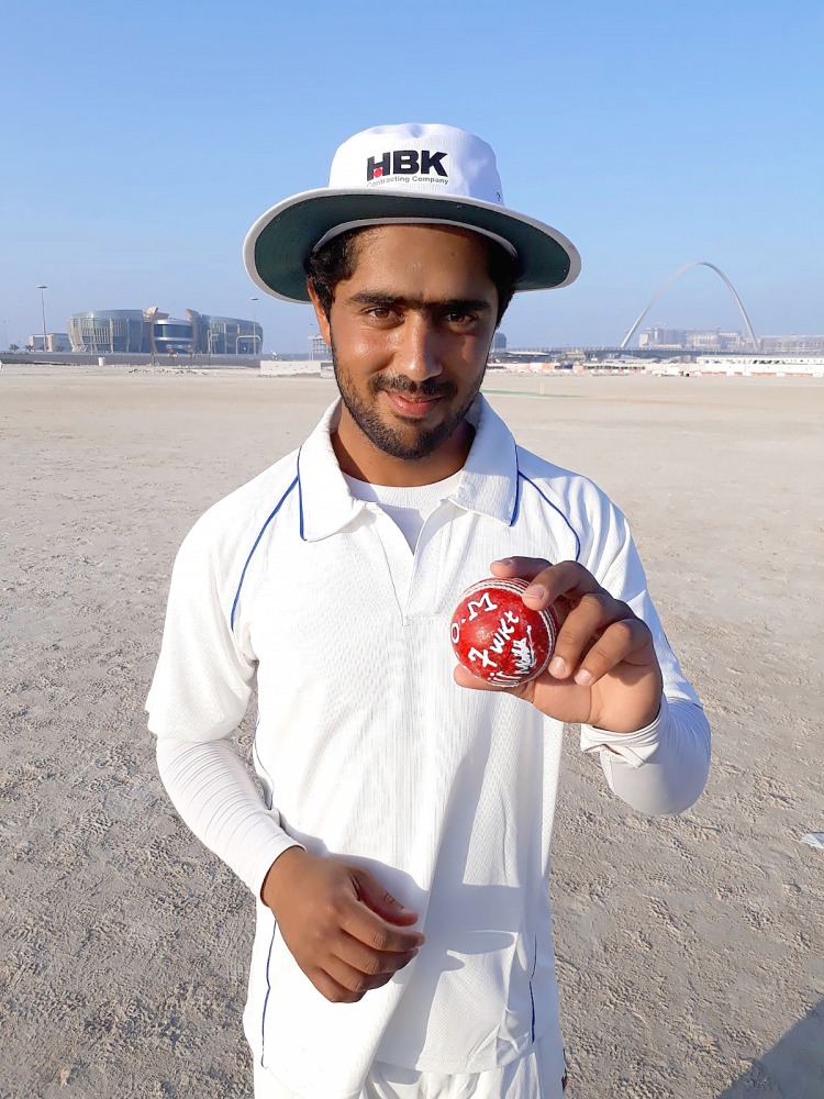 HBK’s bowler Malik poses for a photograph after his match-winning performance of 7 for 50.