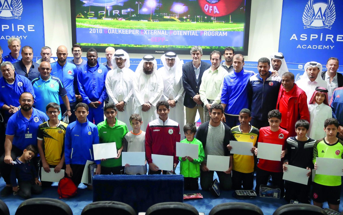 Students and Aspire Academy officials pose for a photograph during the awards ceremony of the Goalkeeper External Potential Programme.