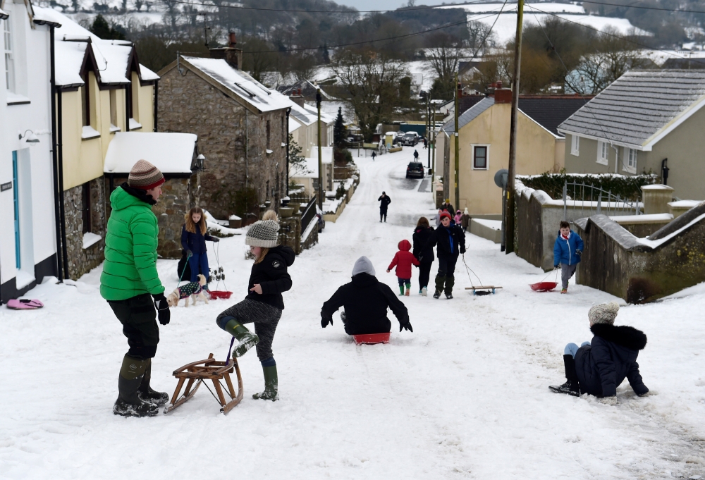 The main high street in the village of St Florence is used as a sledging slope after Storm Emma and heavy snowfall hit the area, in West Wales March 2, 2018. Reuters/Rebecca Naden