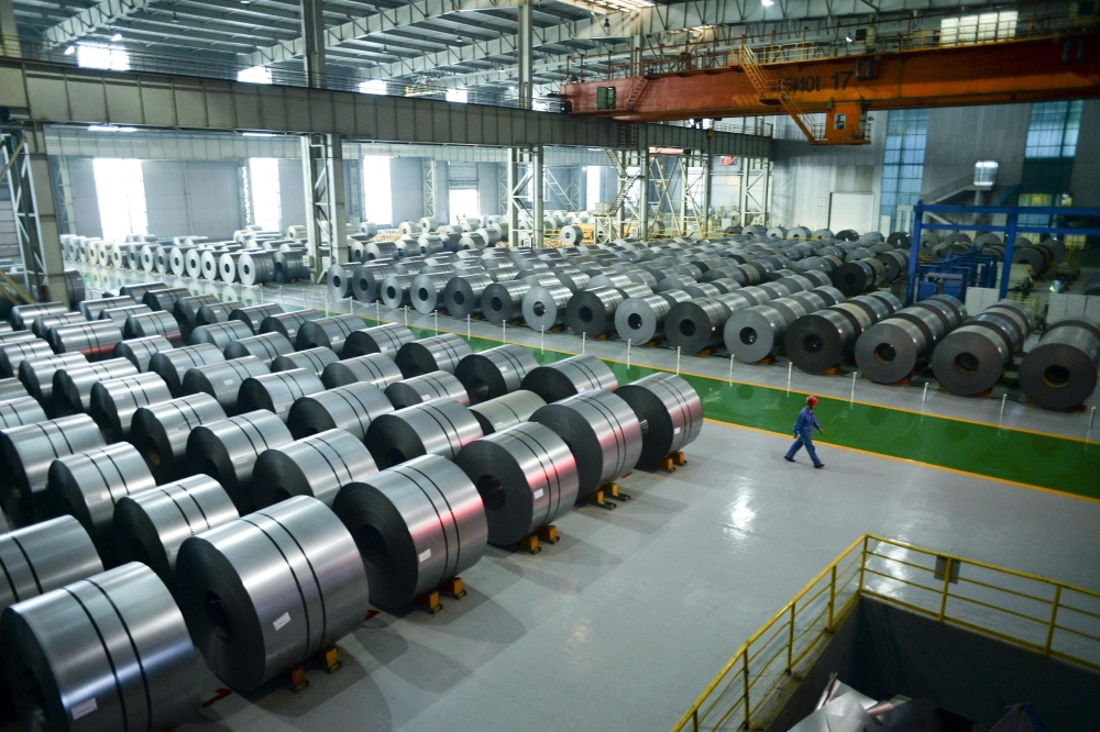 File picture of a worker walking through a warehouse at the Han-steel plant in Handan in China's northern Hebei province, April 21, 2016.  / AFP / WANG ZHAO