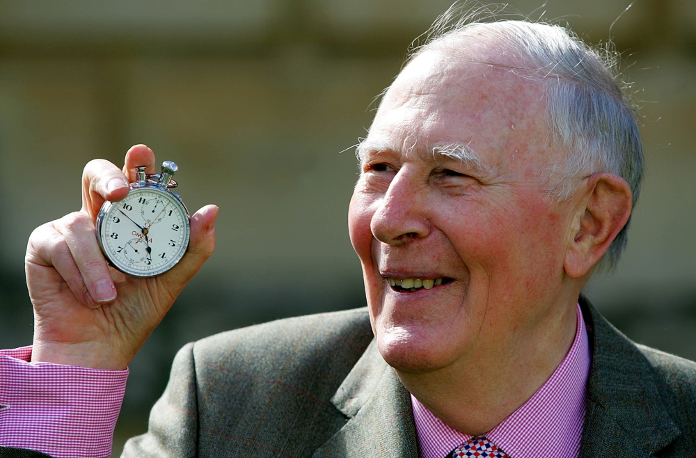 Sir Roger Bannister, who ran the first sub-four-minute mile in 1954, holds the stop watch used by Harold Abrahams to time the race during 50th anniversary celebrations at Pembroke College, Oxford, May 6, 2004. Reuters/David Bebber