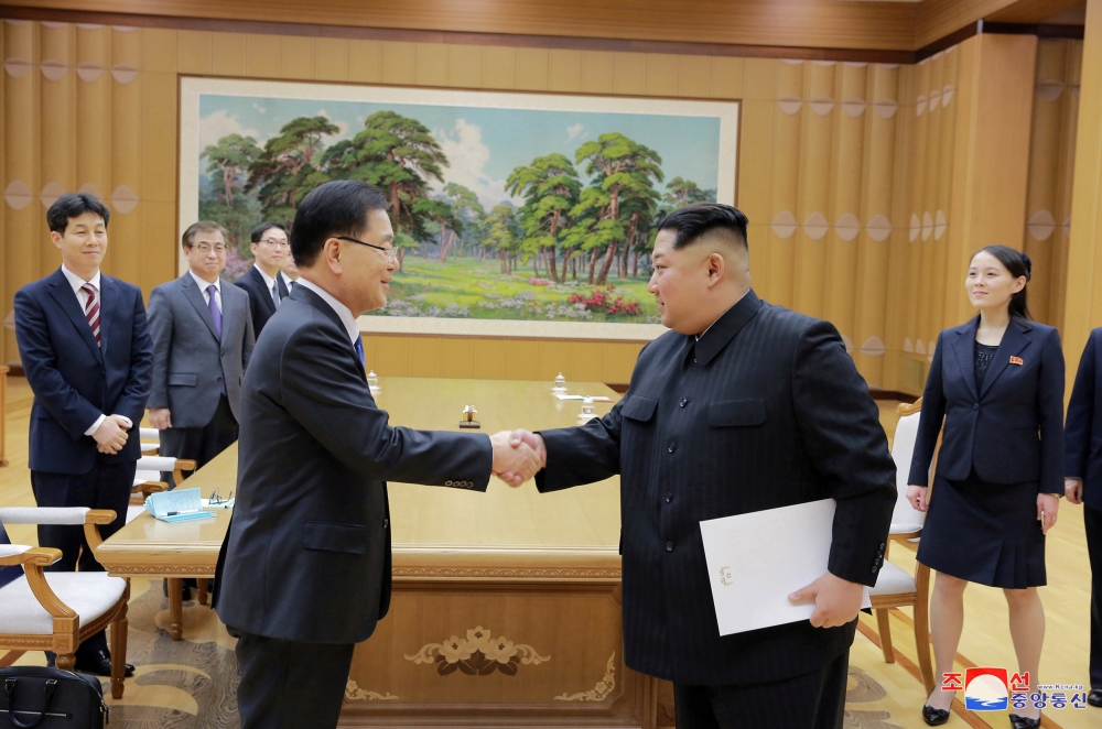 North Korean leader Kim Jong Un shakes hands with Chung Eui-yong who is leading a special delegation of South Korea's President, in this photo released by North Korea's Korean Central News Agency (KCNA) on March 6, 2018. KCNA/via Reuters 