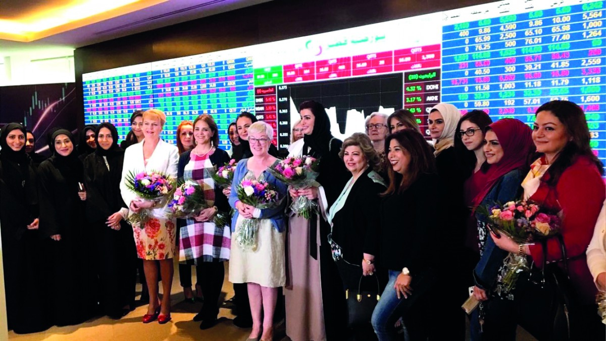 Prominent Qatari women and foreign dignitaries posing for a group picture after marking the International Women’s Day at Qatar Stock Exchange headquarters in West Bay, Doha, yesterday. 