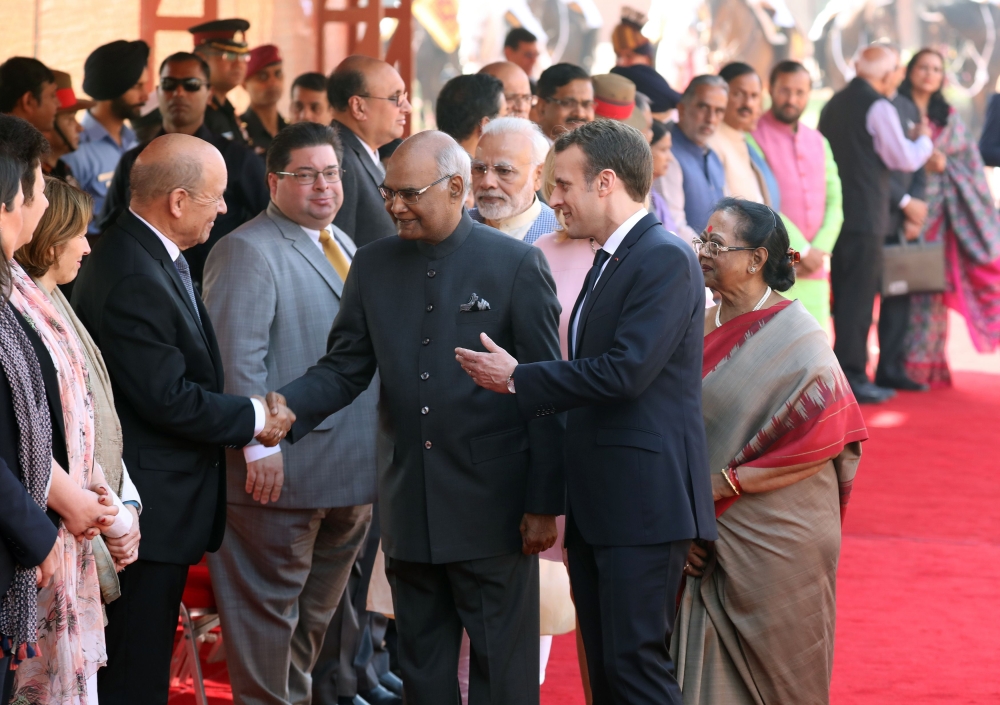 French President Emmanuel Macron (centre R) introduces French Foreign Minister Jean Yves Le Drian (L) to Indian President Ram Nath Kovind (C) during a ceremonial reception at the Indian Presidential Palace in New Delhi on March 10, 2018.  AFP / POOL / Lud