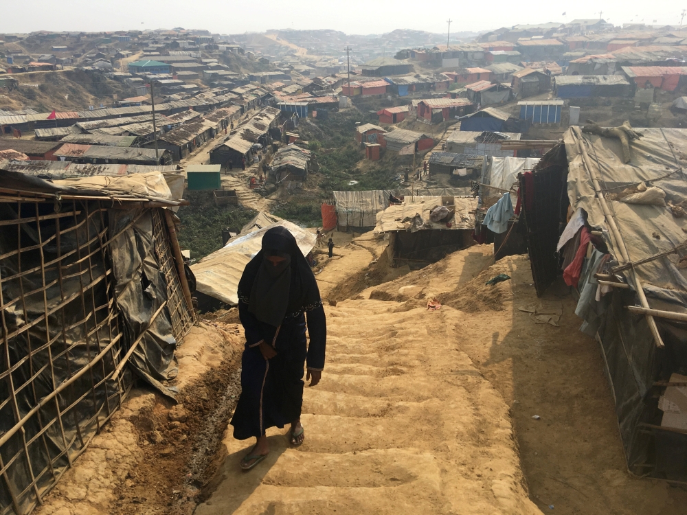 A woman walks up a hill in the Kutupalong camp for Rohingya refugees in southern Bangladesh, February 11, 2018. Picture taken February 11, 2018. REUTERS/Andrew RC Marshall
