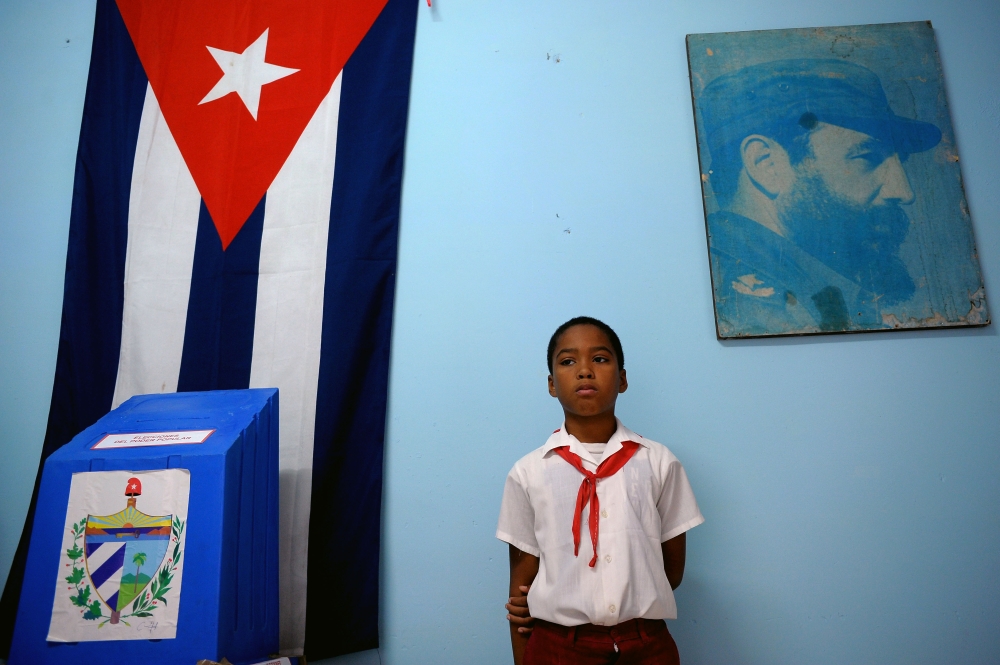 (FILES) In this file photo taken on November 26, 2017 a schoolboy remains standing at a polling station at Nautico neighbourhood in Havana during municipal elections. AFP / YAMIL LAGE