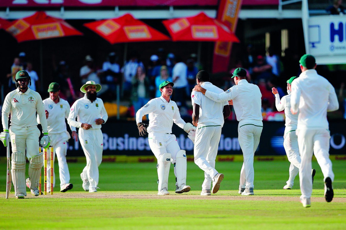 South Africa bowler Kagiso Rabada (4 R) is celebrated by teammates for the wicket of Australia batsman Usman Khawaja during day three of the second Test match between South Africa and Australia at St George's Park in Port Elizabeth, on March 11, 2018. AFP
