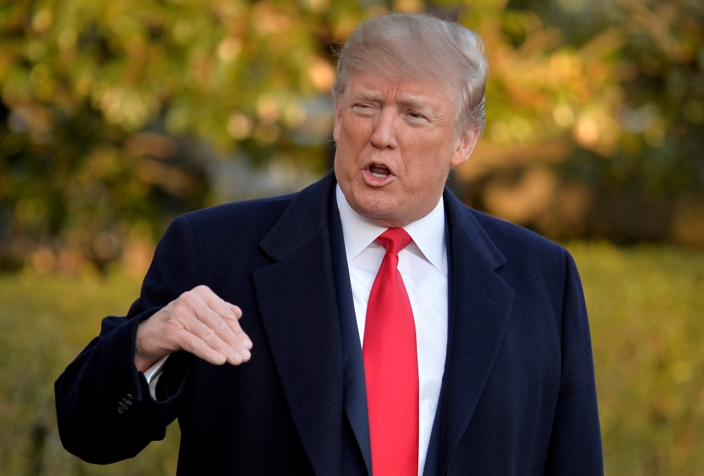 FILE PHOTO: U.S. President Donald Trump responds to a reporter's question as he departs the White House, Washington, DC, U.S., for a day trip to suburban Pittsburgh, Pennsylvania, for a Make America Great Again rally supporting Republican candidate Rick S