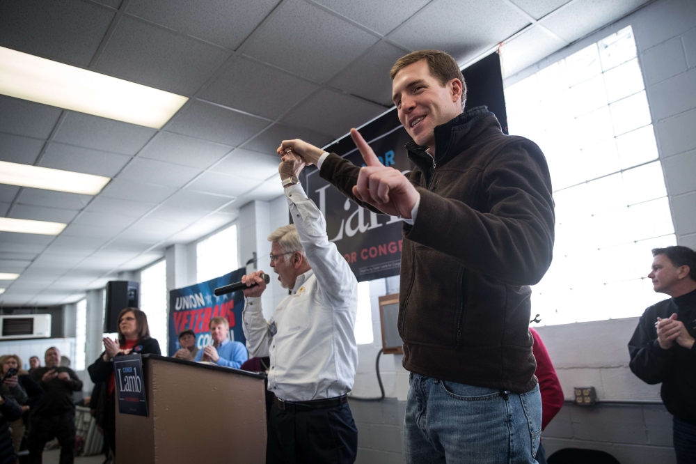 UMWA President Cecil Roberts (L) and Conor Lamb, Democratic Congressional candidate for Pennsylvania's 18th district, gesture at a campaign rally with United Mine Workers of America (UMWA) at the Greene County Fairgrounds, March 11, 2018 in Waynesburg, Pe