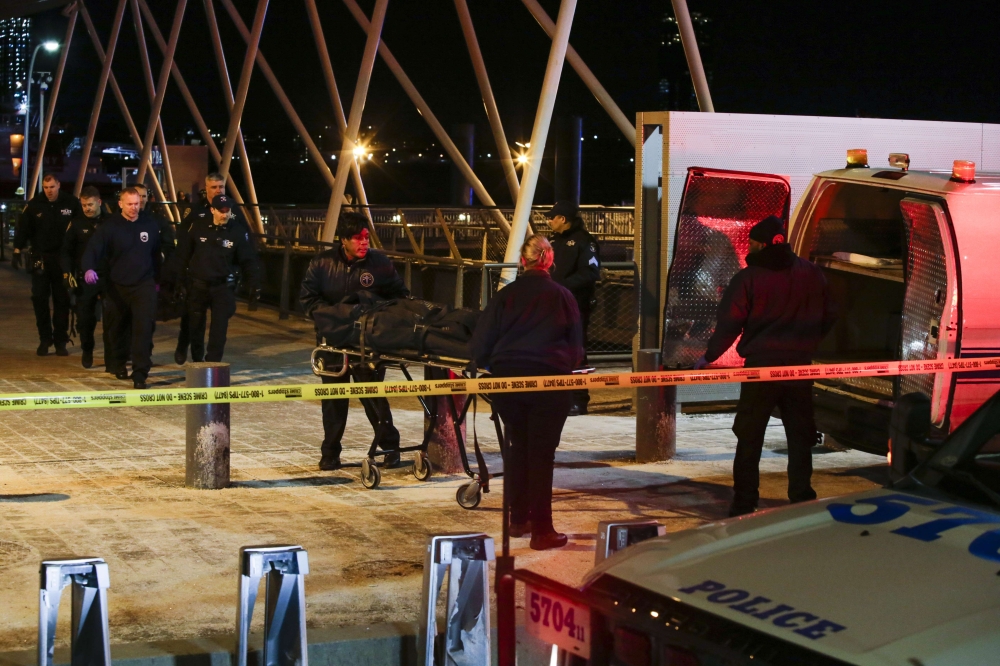 NYPD officers remove the bodies from the scene of a helicopter crash in the East River on March 11, 2018 in New York City. Eduardo Munoz Alvarez/Getty Images/AFP