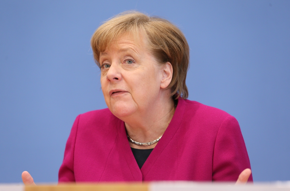 German Chancellor Angela Merkel (L) attends the signing ceremony of the conservative CDU/CSU party and the Social Democrats to form a new government in Berlin, on March 12, 2018.  Cüneyt Karada? - Anadolu
