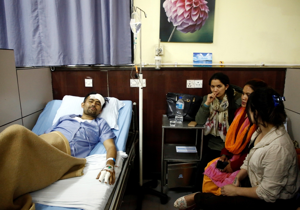 Basanta Bohara, 27, a survivor from the US-Bangla plane crash lies on a hospital bed while undergoing treatment in Kathmandu, Nepal March 12, 2018. Reuters/Navesh Chitrakar